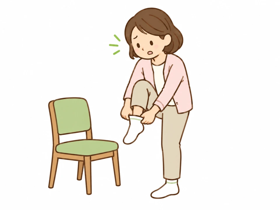 片脚で靴下を履こうとしている女性