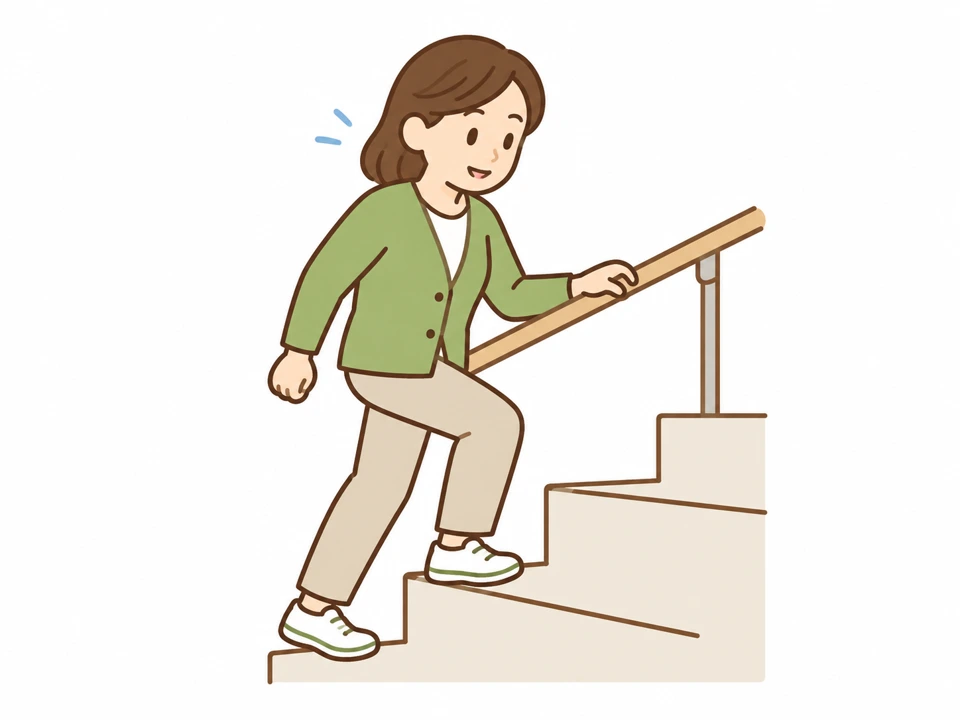手すりを使って階段を上る女性